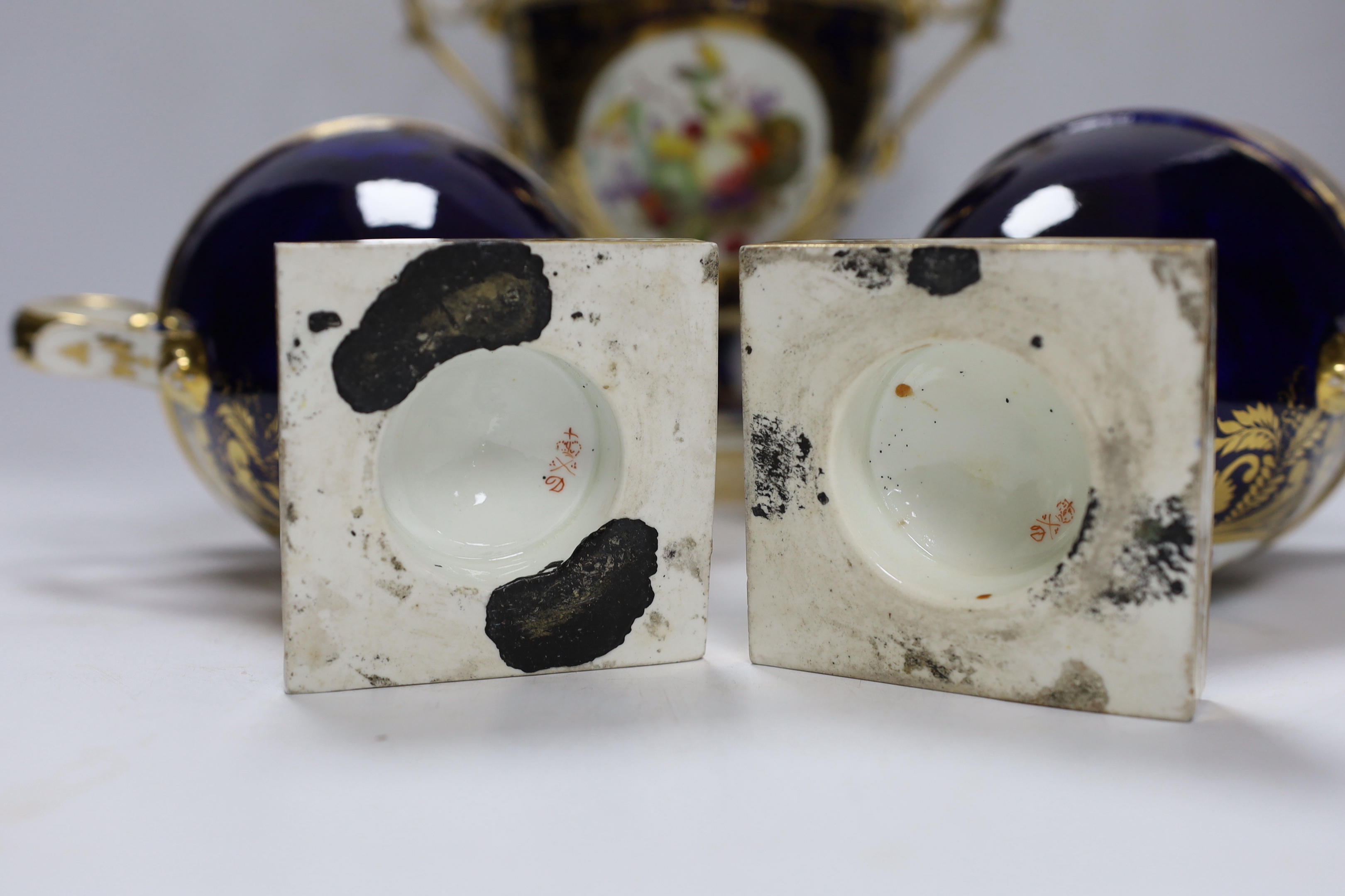 A garniture of three early 19th century Derby vases painted with fruit, tallest 23cm
